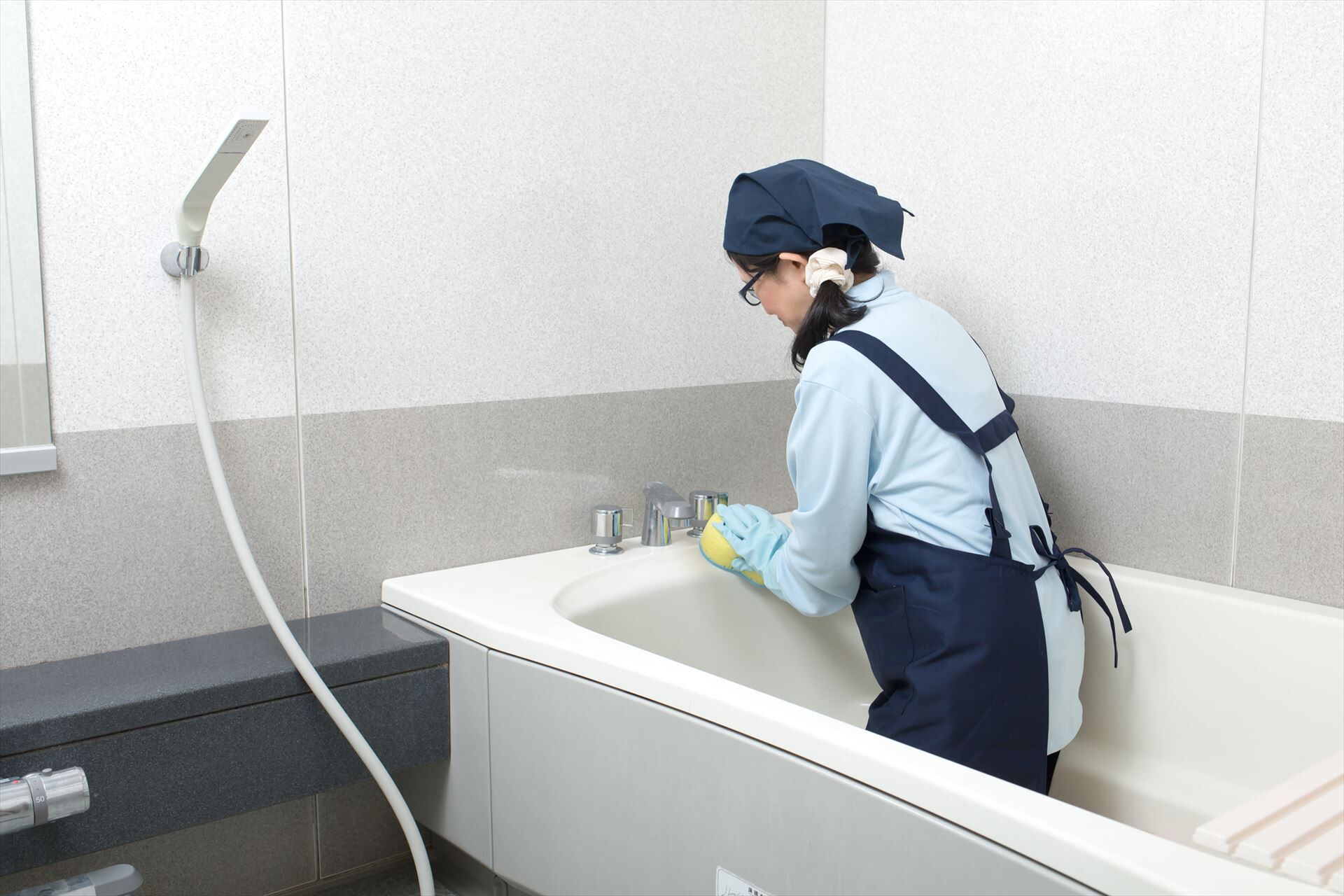 風呂掃除をするスタッフ